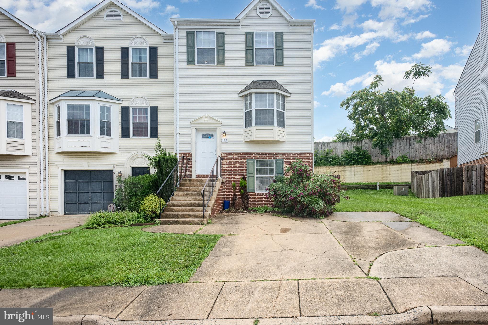 107 Wimbeldon Court Stafford, VA 22556 - Photo 1 of 32 a front view of a house with a garden