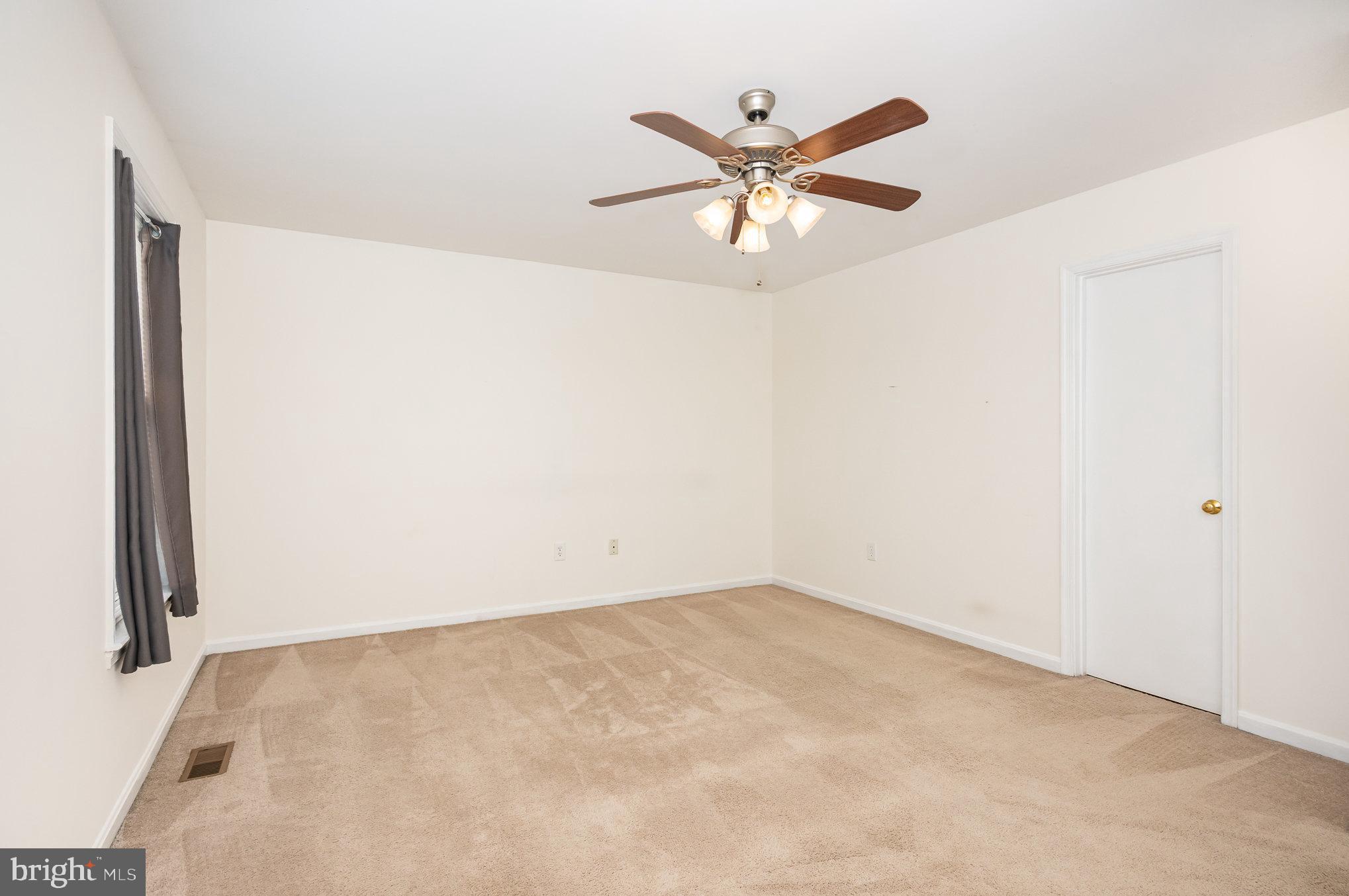 107 Wimbeldon Court Stafford, VA 22556 - Photo 13 of 32 an empty room with a window and a chandelier fan