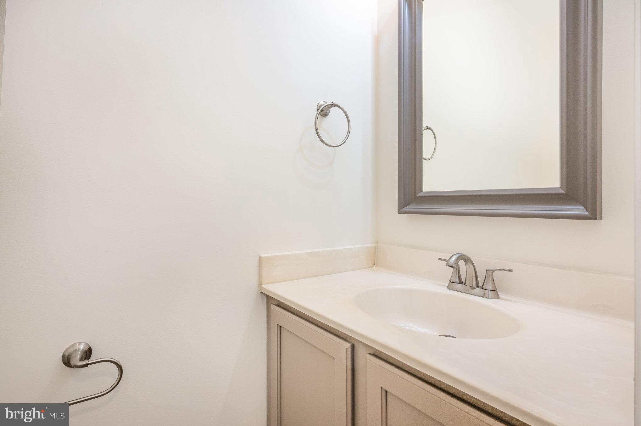 107 Wimbeldon Court Stafford, VA 22556 - Photo 14 of 32 a bathroom with a sink and mirror