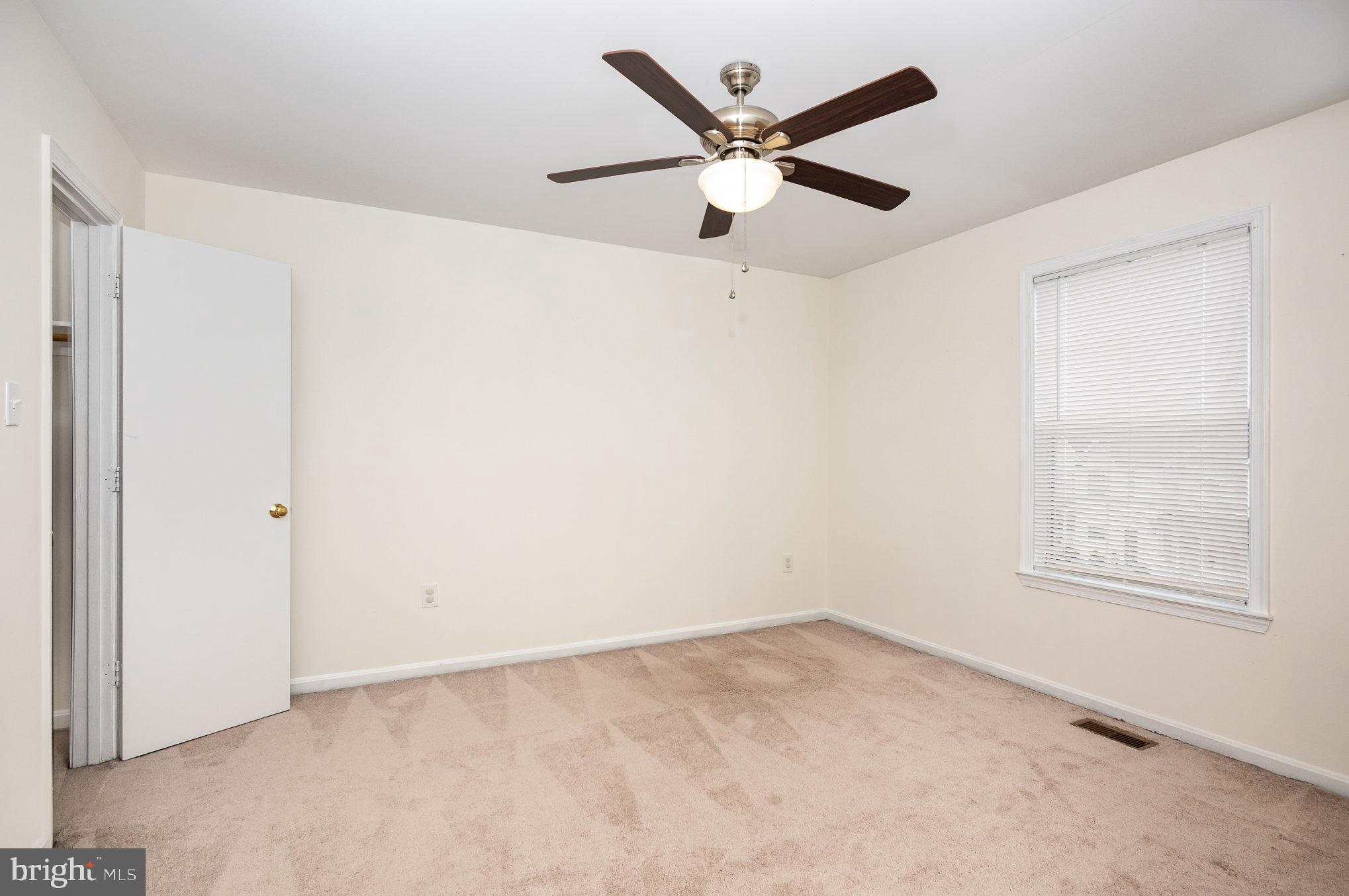 107 Wimbeldon Court Stafford, VA 22556 - Photo 16 of 32 an empty room with a window and a fan