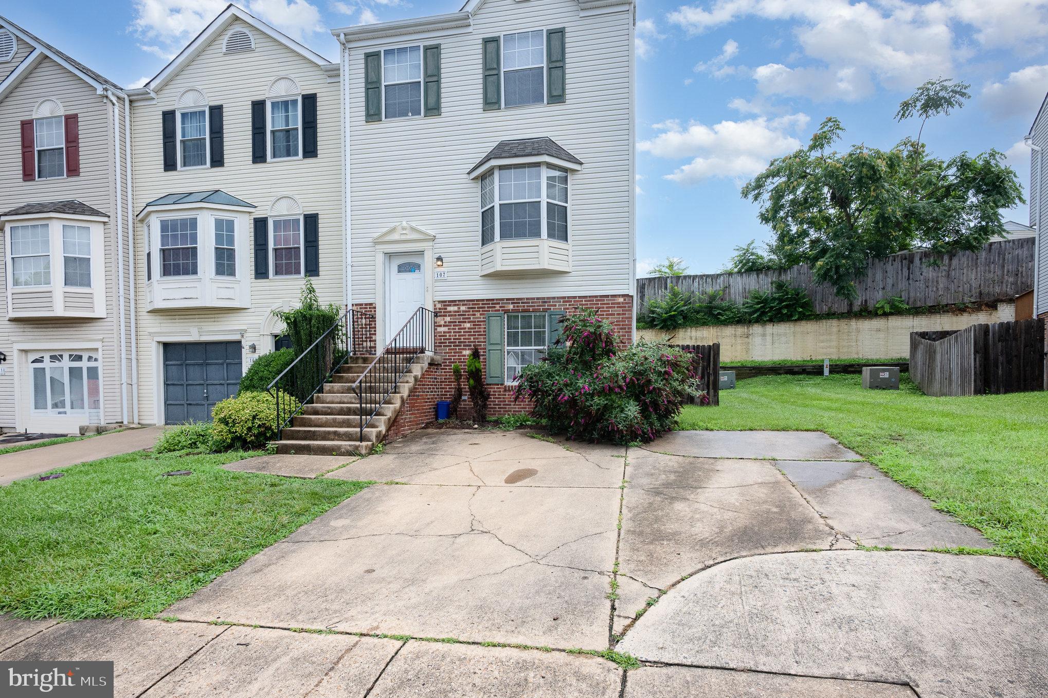 107 Wimbeldon Court Stafford, VA 22556 - Photo 2 of 32 a front view of a house with a yard