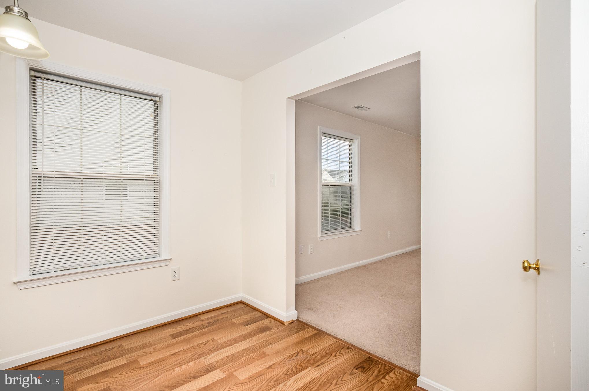 107 Wimbeldon Court Stafford, VA 22556 - Photo 10 of 32 a view of an empty room with wooden floor and a window