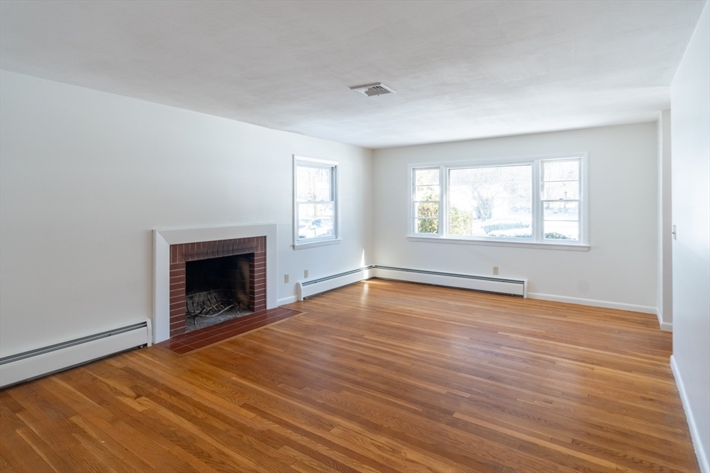50 Oak Road Longmeadow, MA 01106 - Photo 12 of 37 an empty room with wooden floor fireplace and windows