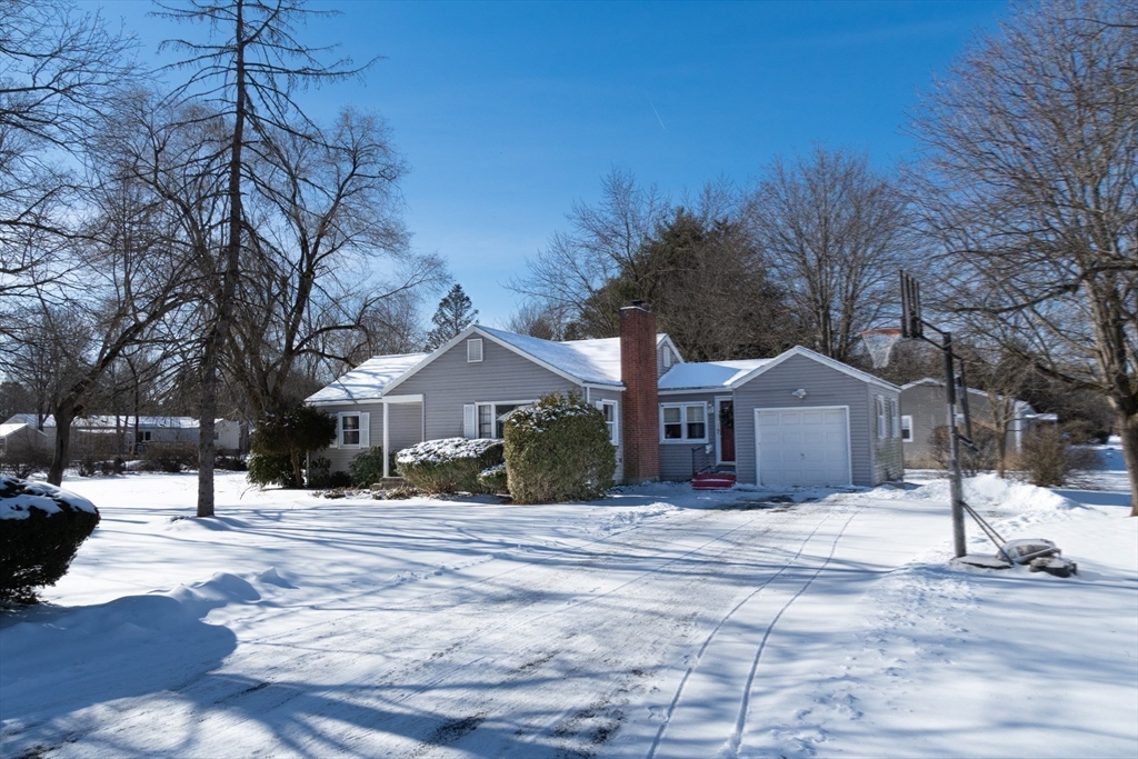 50 Oak Road Longmeadow, MA 01106 - Photo 2 of 37 a front view of a house with a yard covered in snow