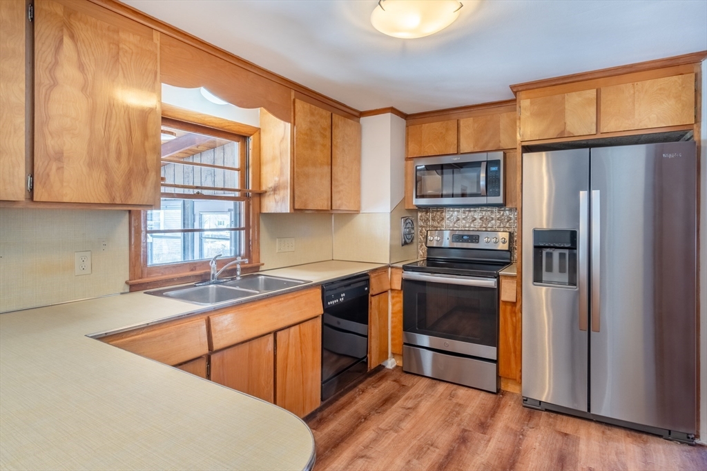 50 Oak Road Longmeadow, MA 01106 - Photo 7 of 37 a kitchen with stainless steel appliances granite countertop a stove a sink and a refrigerator