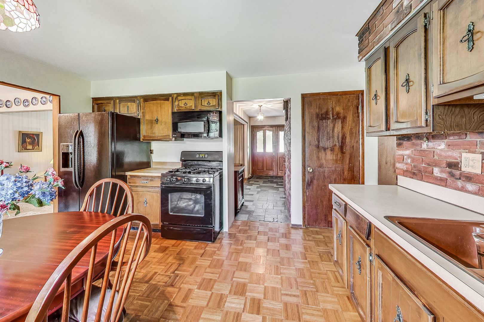 544 Northgate Road Lindenhurst, IL 60046 - Photo 11 of 32 a kitchen with stainless steel appliances granite countertop a refrigerator and a stove top oven