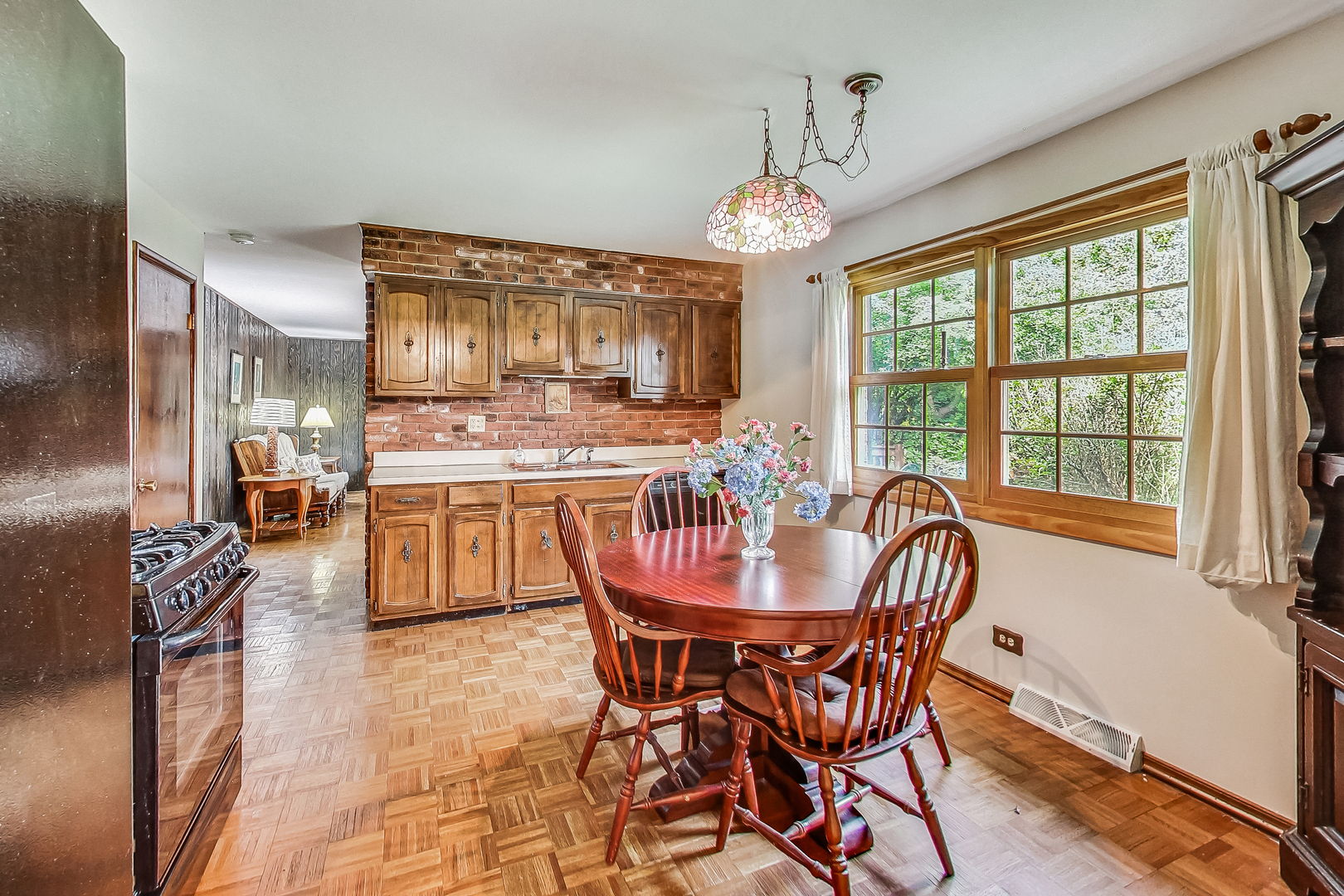 544 Northgate Road Lindenhurst, IL 60046 - Photo 12 of 32 a dining room with furniture a chandelier and wooden floor