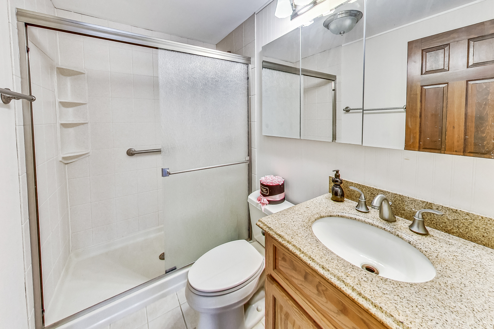 544 Northgate Road Lindenhurst, IL 60046 - Photo 19 of 32 a bathroom with a granite countertop sink toilet and shower