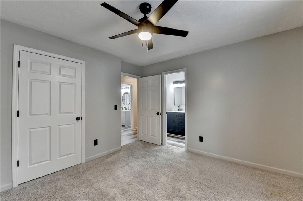 801 Davis Street Monroe, GA 30655 - Photo 25 of 33 wooden floor in an empty room and a ceiling fan