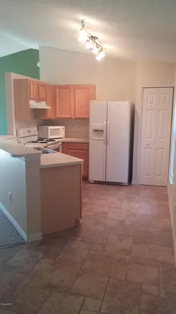 a kitchen with cabinets a island and stainless steel appliances