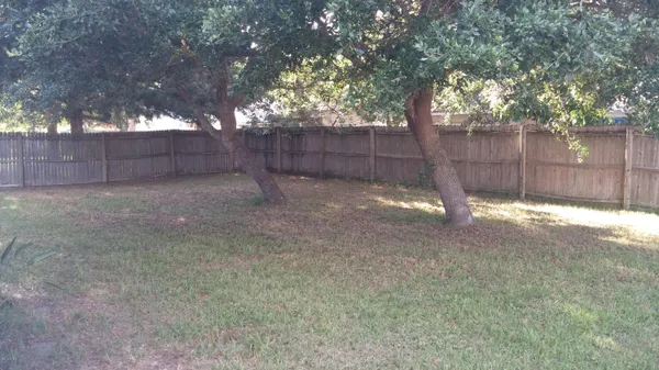a backyard of a house with lots of green space