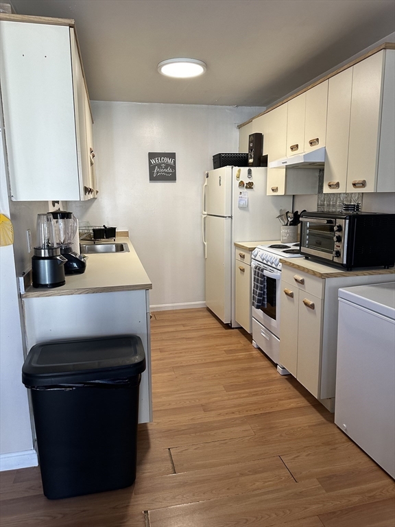 20 Knox Street, Unit 24 Lawrence, MA 01841 - Photo 5 of 13 a kitchen with stainless steel appliances a stove refrigerator sink and cabinets