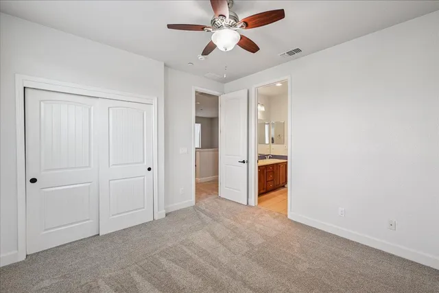 a bathroom with a sink double vanity granite tub and a mirror