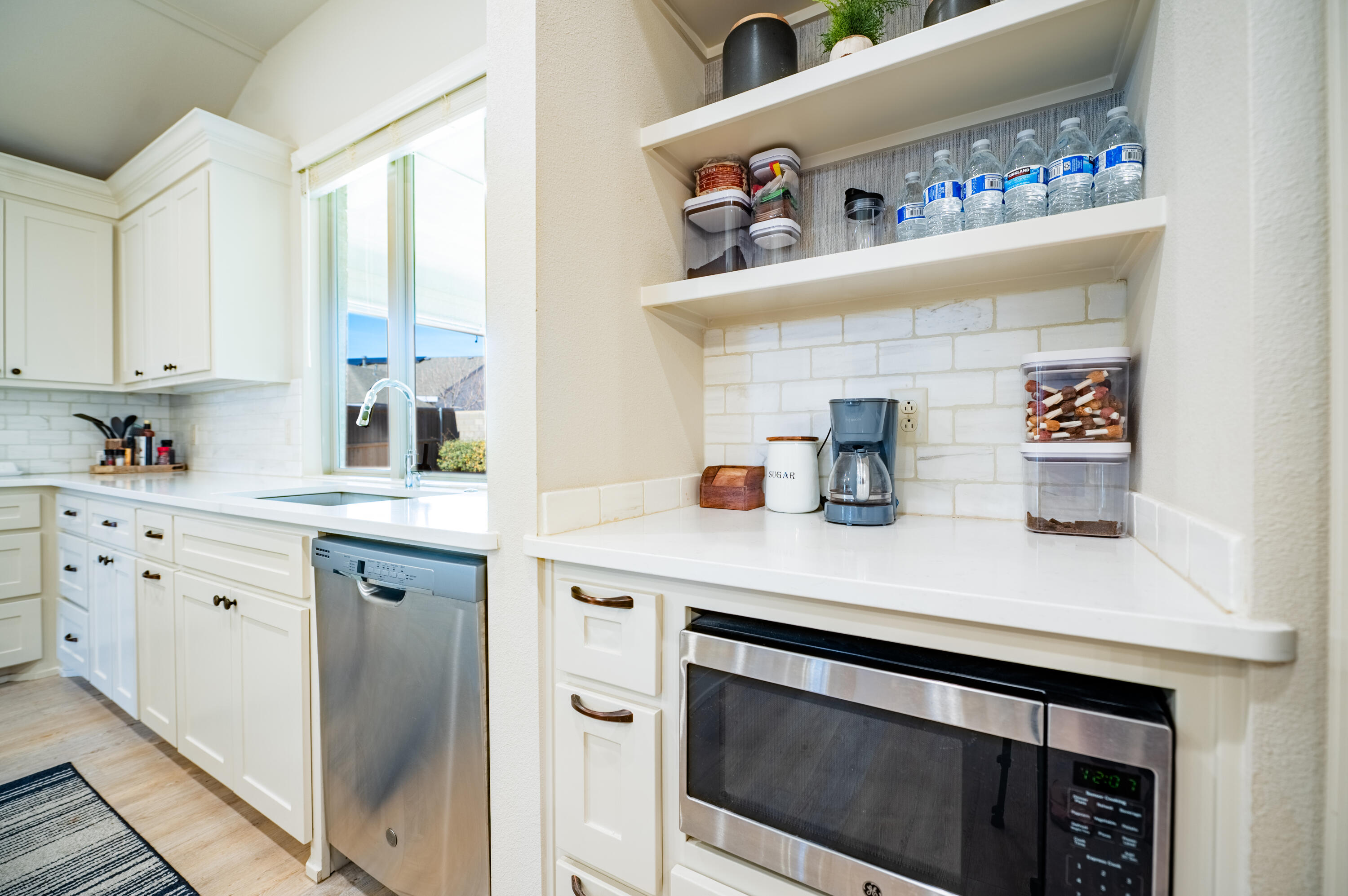 3442 126th Street Lubbock, TX 79423 - Photo 11 of 53 a kitchen with white cabinets and appliances