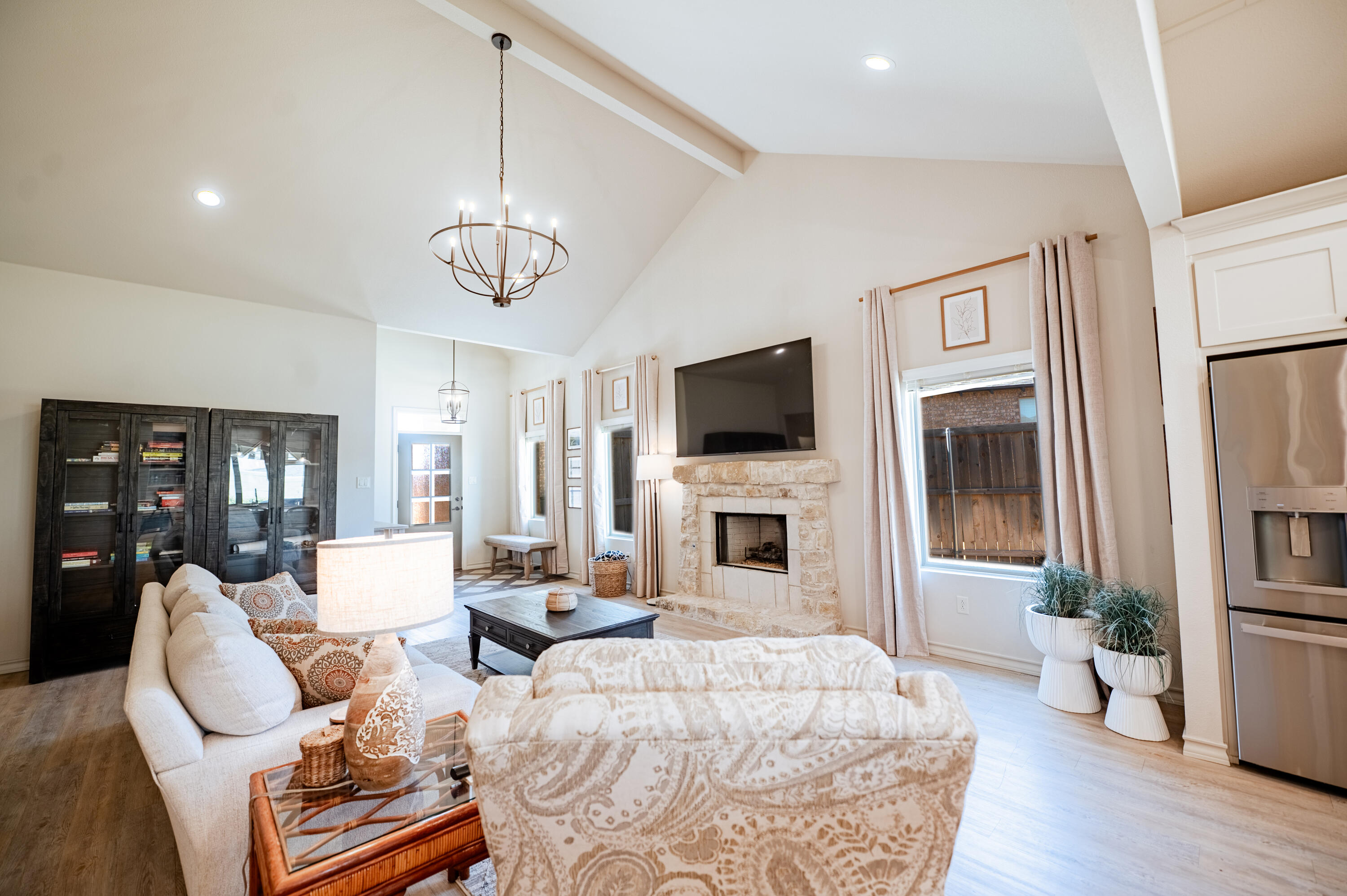 3442 126th Street Lubbock, TX 79423 - Photo 14 of 53 a living room with furniture a fireplace and a flat screen tv