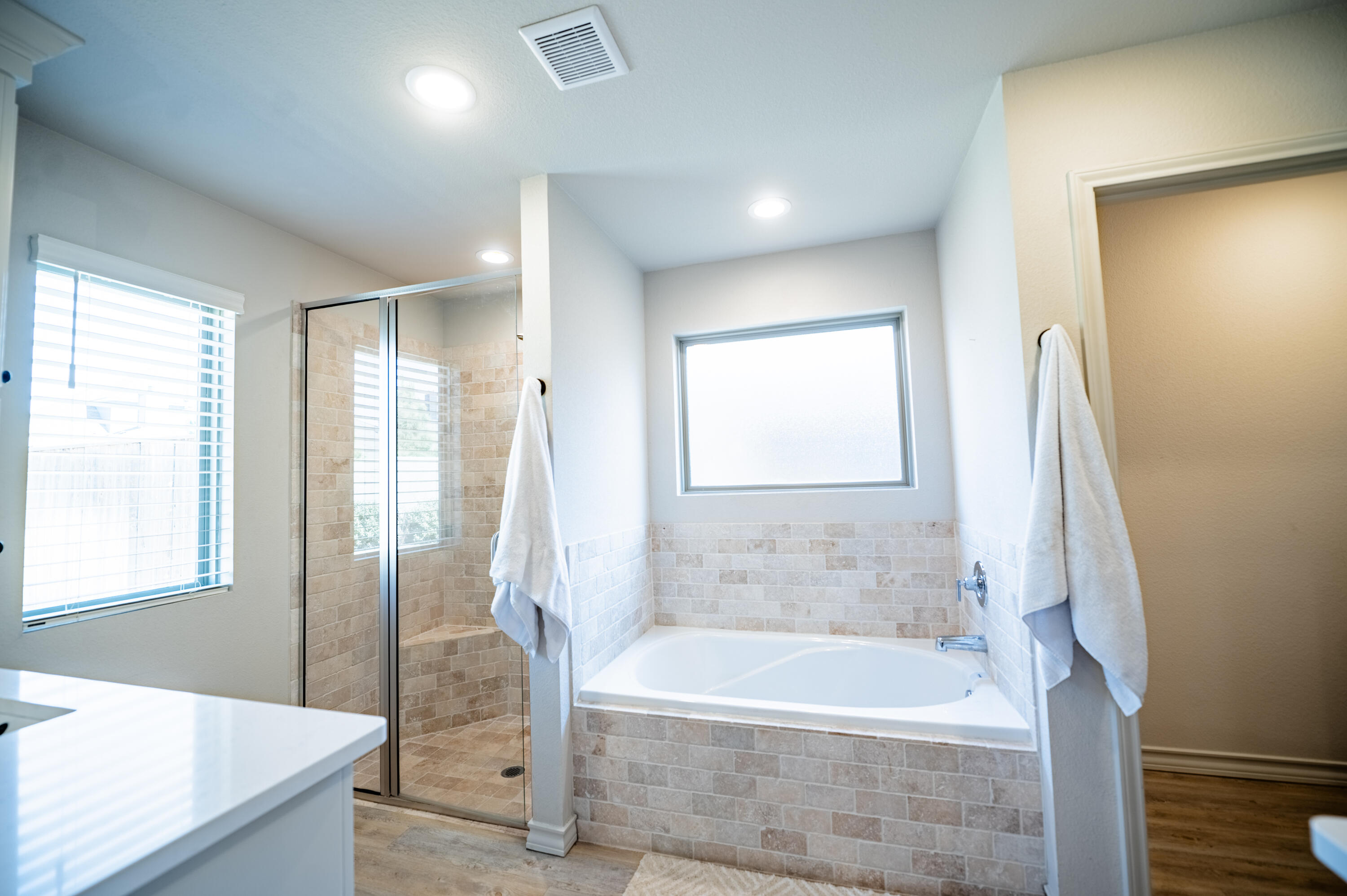 3442 126th Street Lubbock, TX 79423 - Photo 17 of 53 a bathroom with a bathtub and a shower