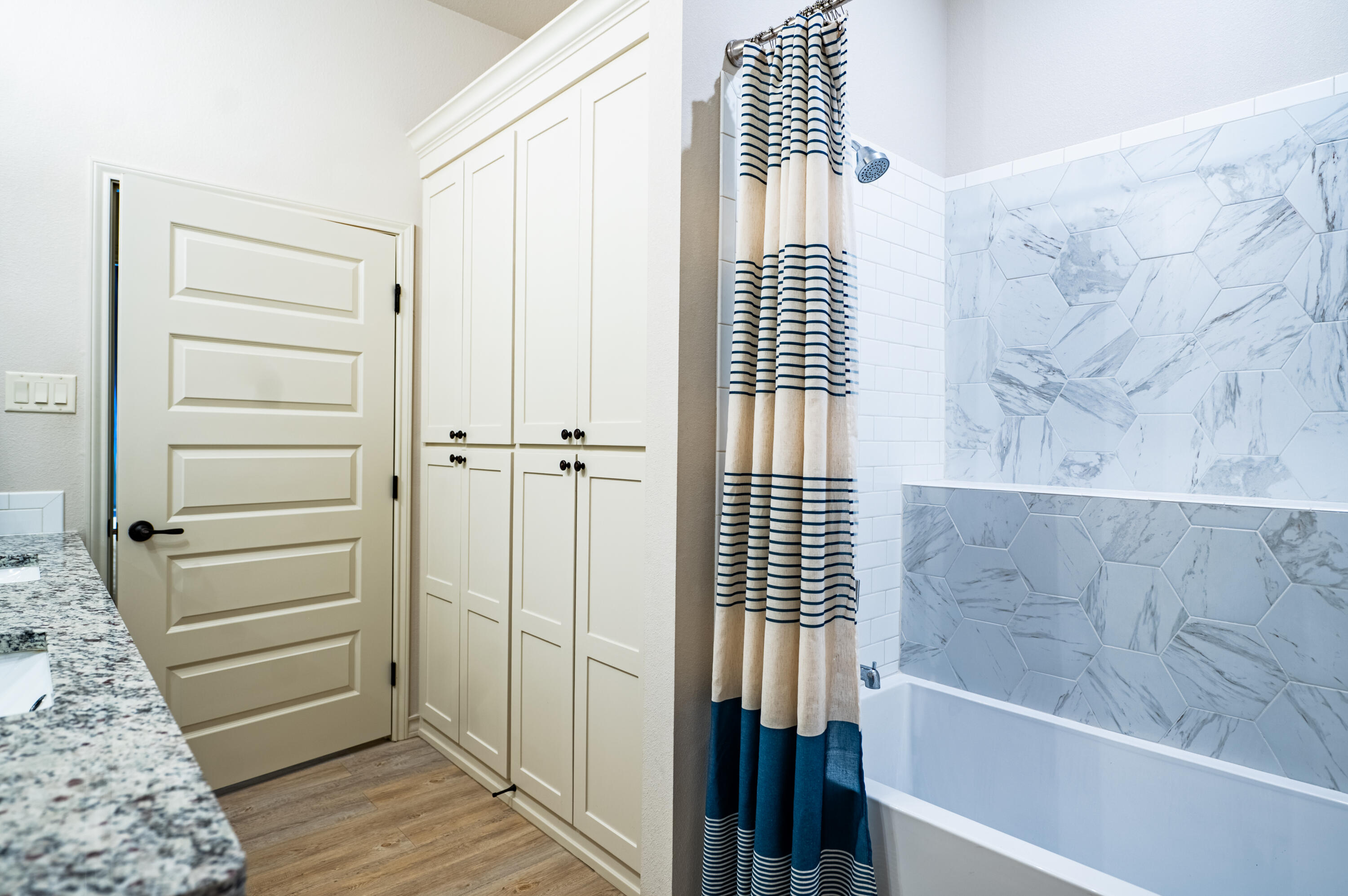 3442 126th Street Lubbock, TX 79423 - Photo 27 of 53 a bathroom with a bathtub and shower