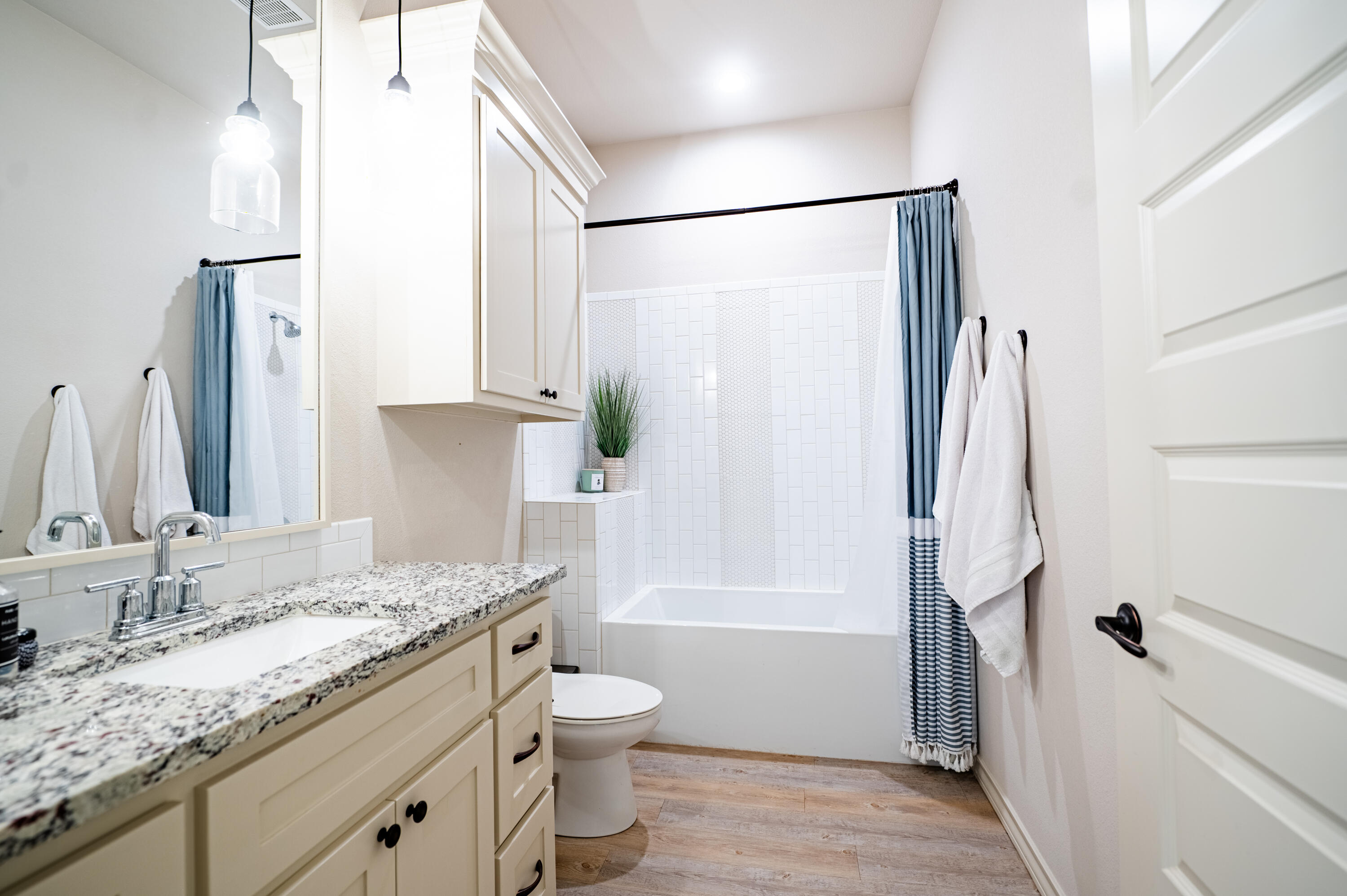3442 126th Street Lubbock, TX 79423 - Photo 29 of 53 a bathroom with a granite countertop sink toilet and shower