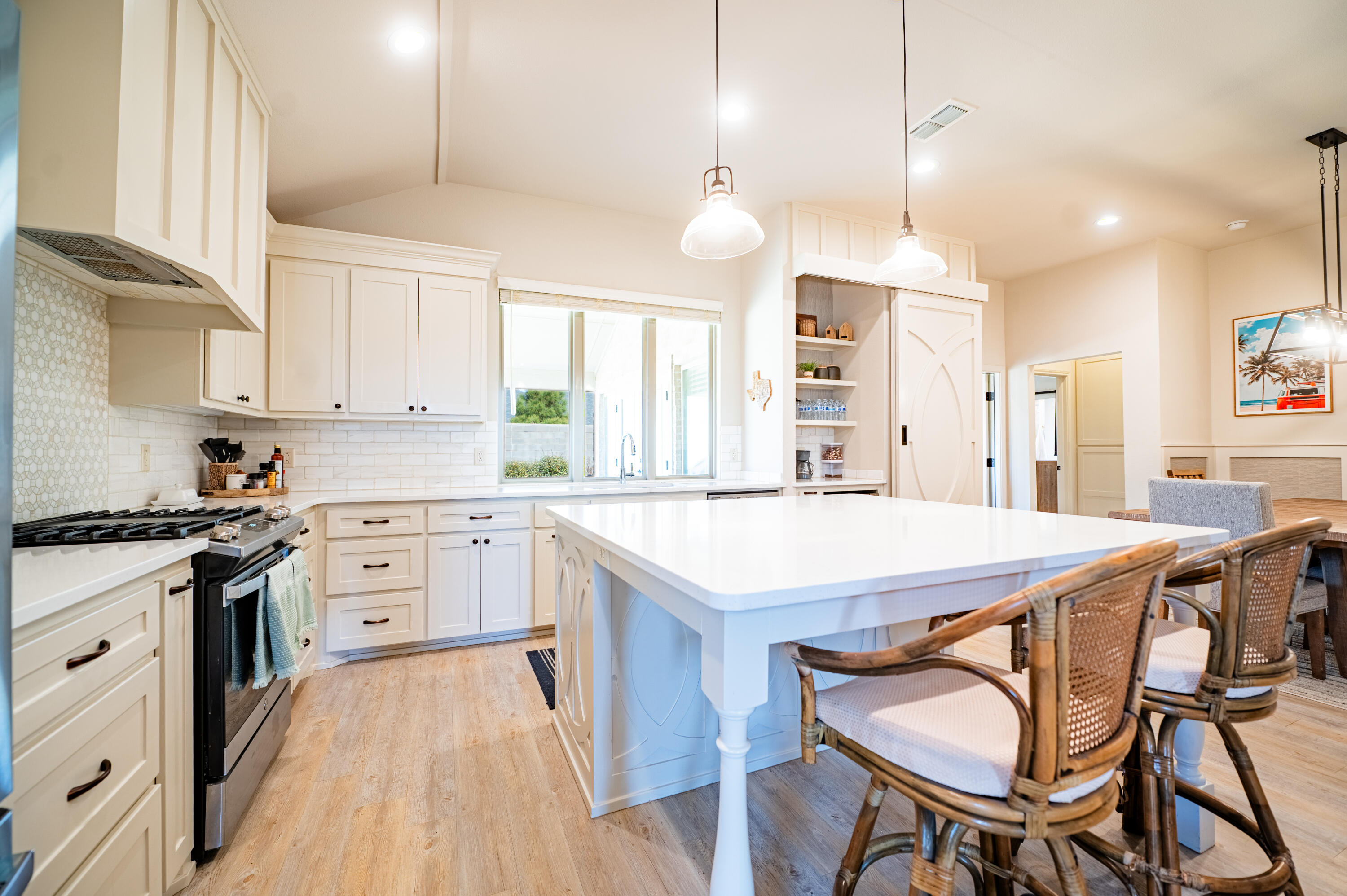3442 126th Street Lubbock, TX 79423 - Photo 9 of 53 a kitchen with stainless steel appliances granite countertop a stove a sink dishwasher a stove a dining table and chairs with wooden floor