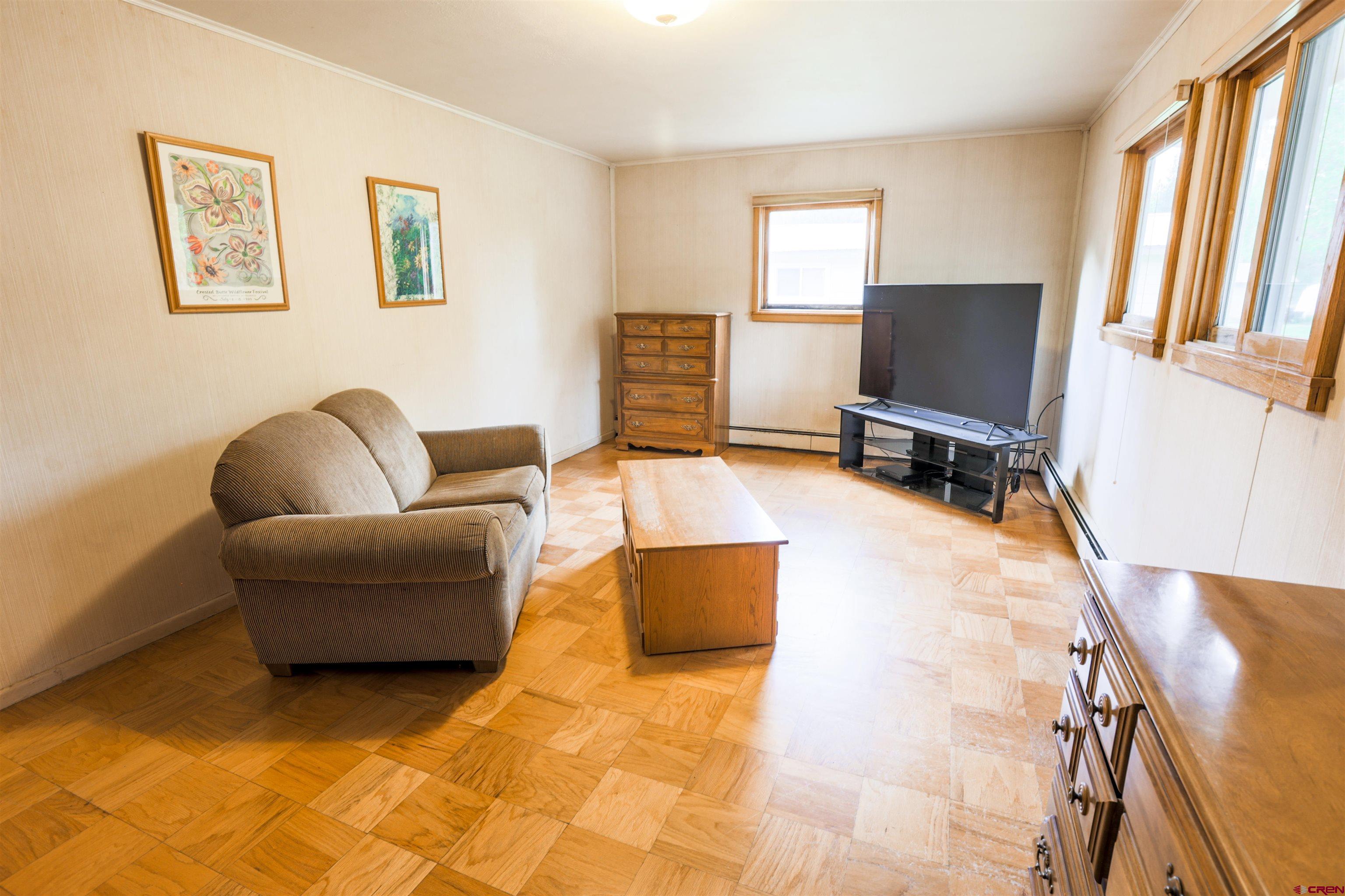 128 Bevington Road Gunnison, CO 81230 - Photo 12 of 37 a living room with furniture and a flat screen tv