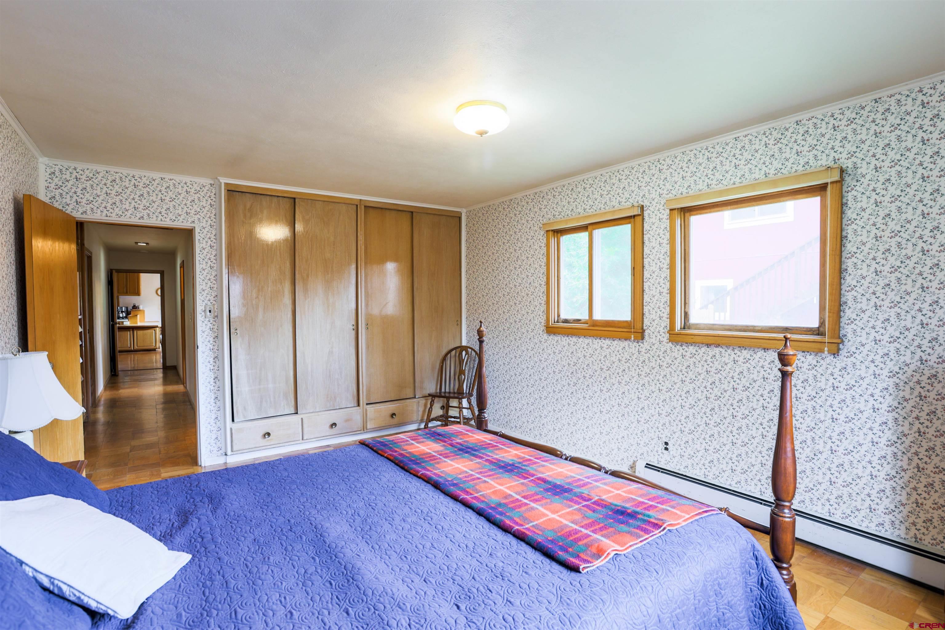 128 Bevington Road Gunnison, CO 81230 - Photo 13 of 37 a bedroom with a bed and wooden floor