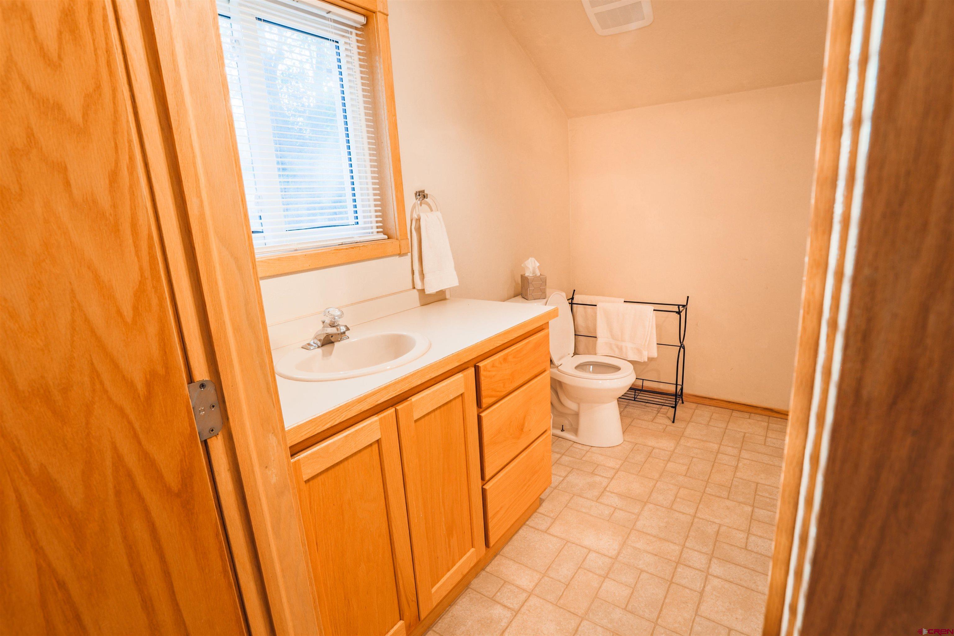 128 Bevington Road Gunnison, CO 81230 - Photo 20 of 37 a bathroom with a sink a toilet and shower curtain