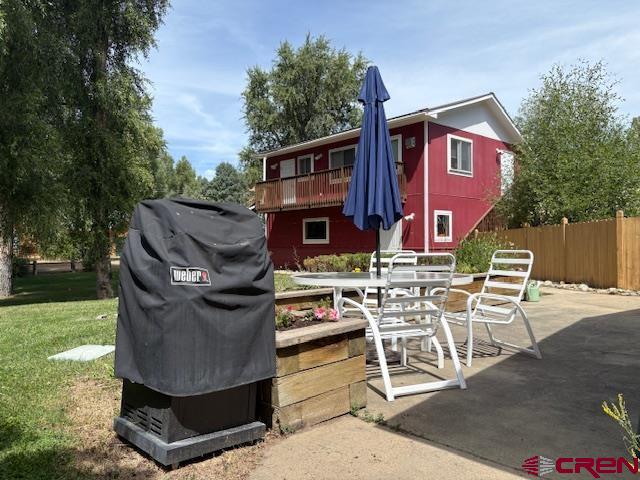 128 Bevington Road Gunnison, CO 81230 - Photo 27 of 37 a view of a patio with table and chairs with wooden fence and plants