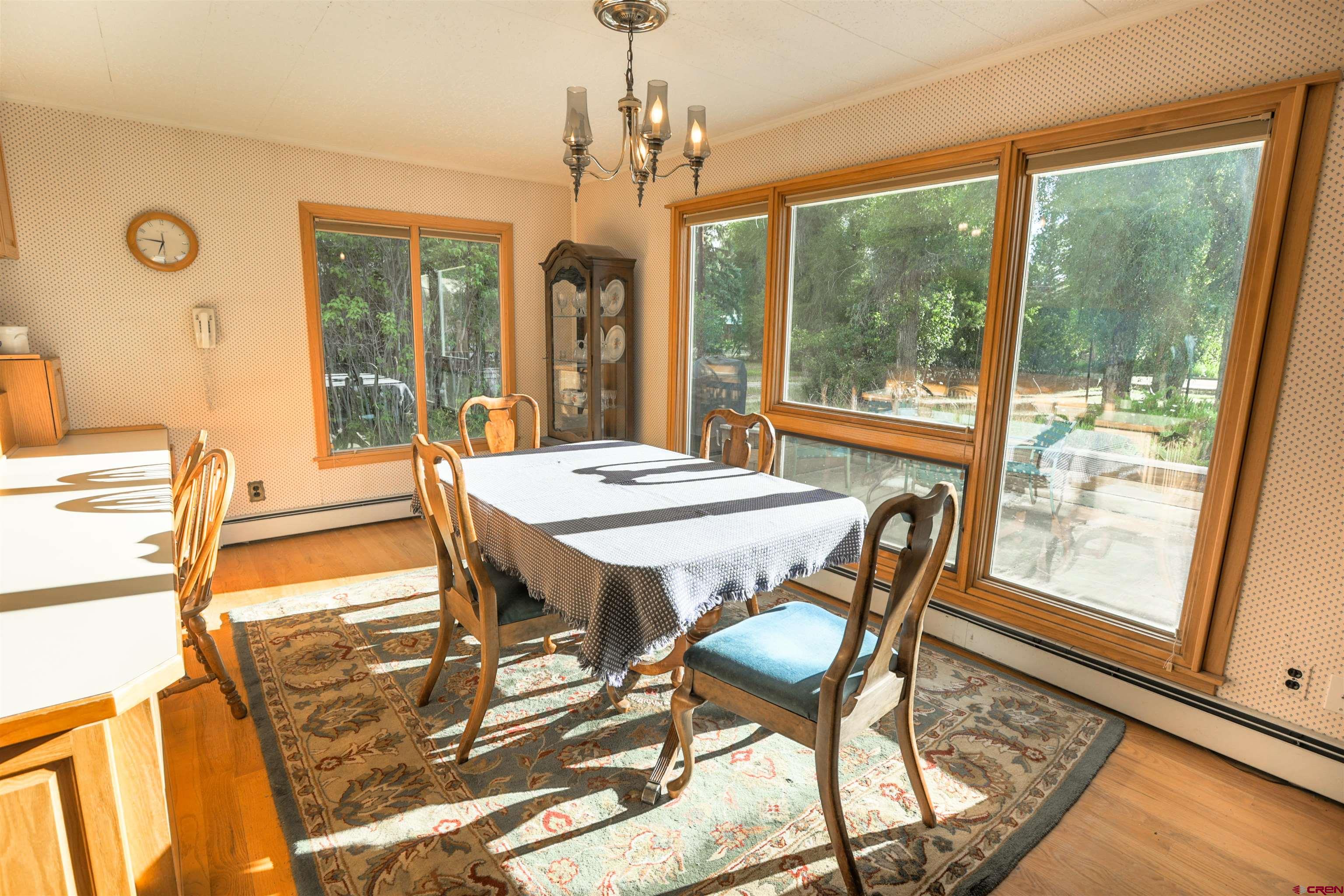 128 Bevington Road Gunnison, CO 81230 - Photo 31 of 37 a view of a dining room with furniture large windows and wooden floor
