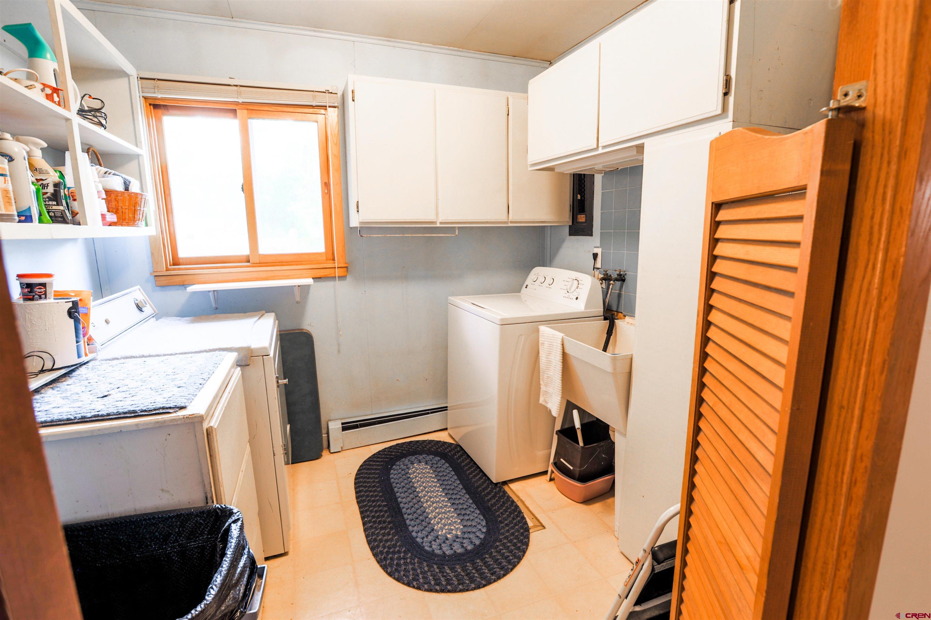 128 Bevington Road Gunnison, CO 81230 - Photo 9 of 37 a utility room with sink dryer and washer