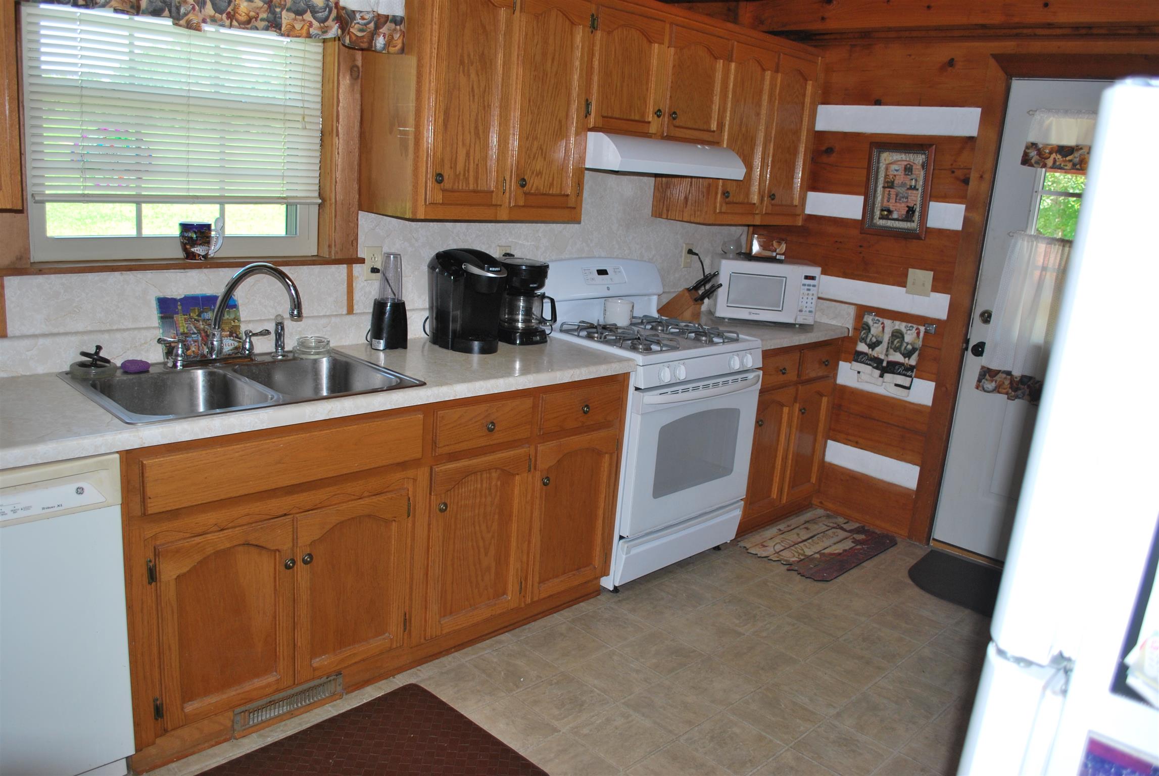 5729 Keysburg Road Adams, TN 37010 - Photo 20 of 30 a kitchen with stainless steel appliances granite countertop a sink stove and refrigerator
