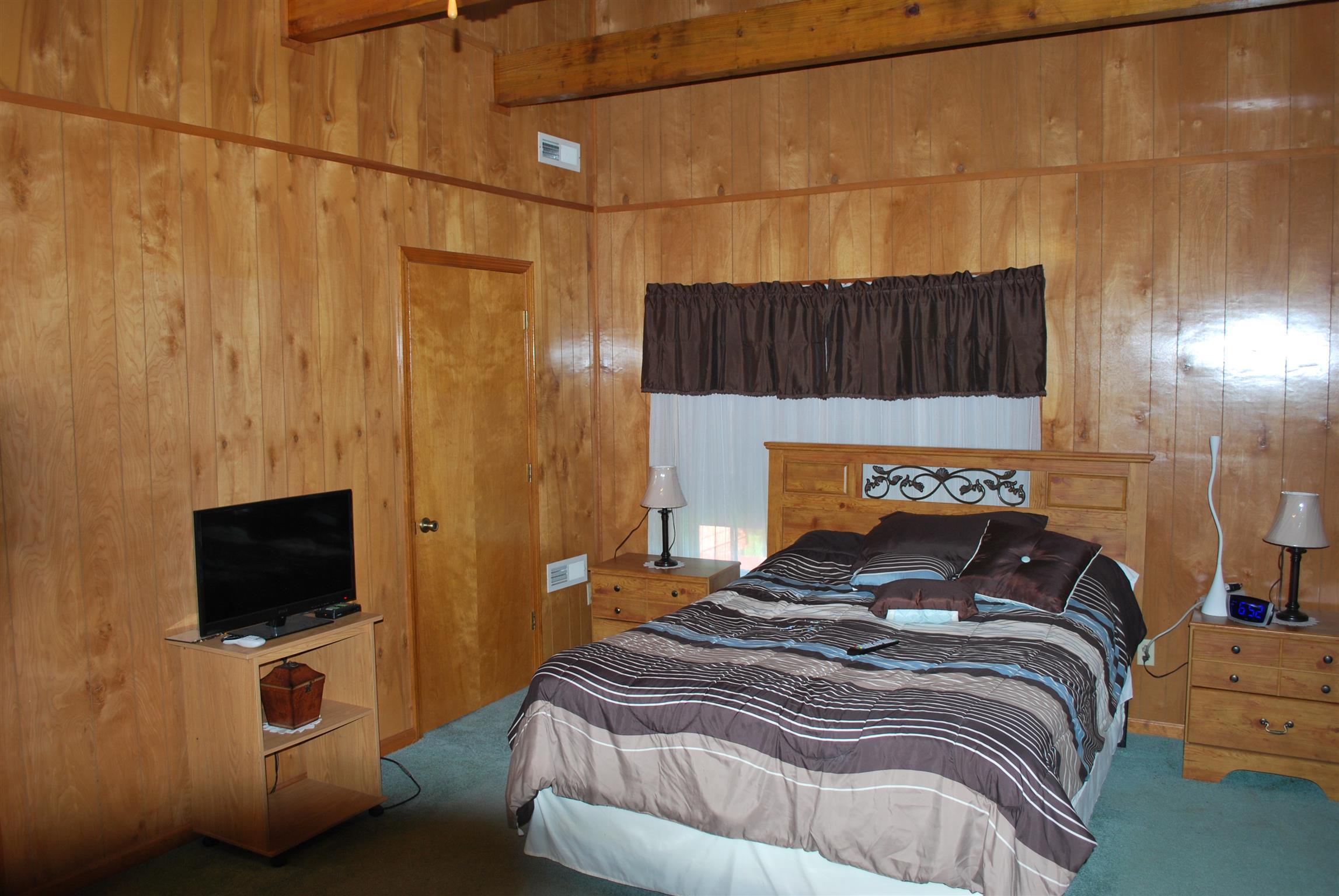 5729 Keysburg Road Adams, TN 37010 - Photo 27 of 30 a bedroom with a bed and a flat screen tv