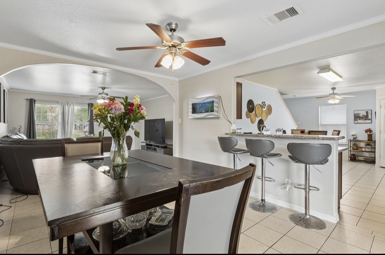 7118 Rising Brook Drive Cypress, TX 77433 - Photo 6 of 21 a view of a dining room with furniture and a chandelier fan