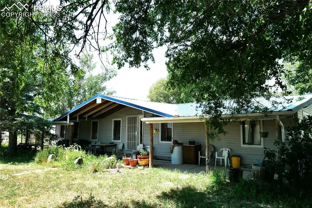 a front view of house with a garden