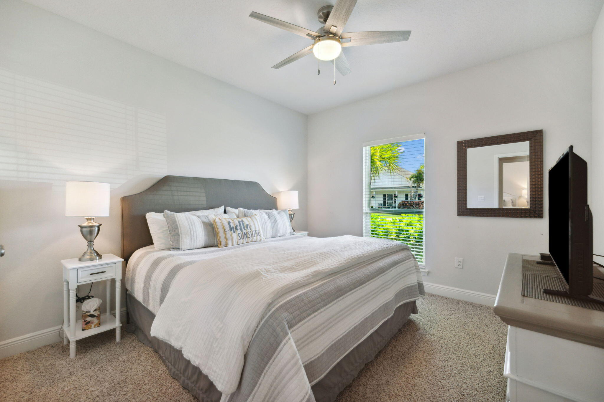 77 Palmview Lane Santa Rosa Beach, FL 32459 - Photo 19 of 37 a bedroom with a bed tv and a chandelier