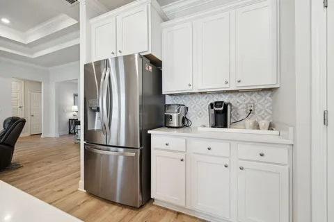 a kitchen with stainless steel appliances kitchen island granite countertop a kitchen island hardwood floor and a sink
