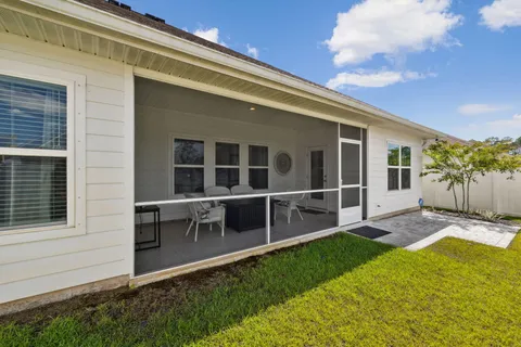 a view of an house with backyard space and balcony