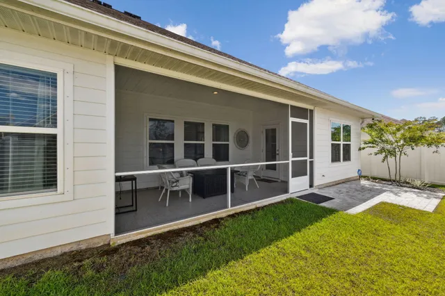 a view of an house with backyard space and balcony