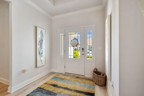 a bedroom with a bed tv and a chandelier