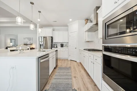a kitchen with a sink appliances and a counter top space