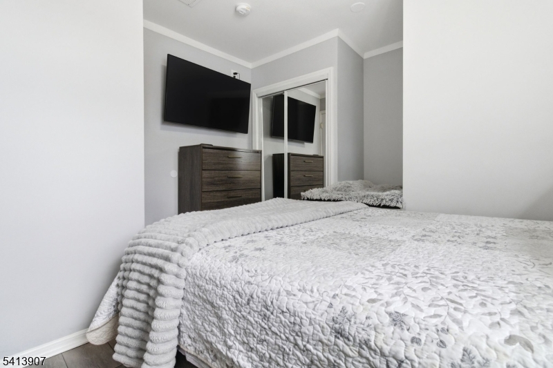 32 Cedar Avenue Elizabeth, NJ 07202 - Photo 19 of 32 a bedroom with a bed and a flat screen tv