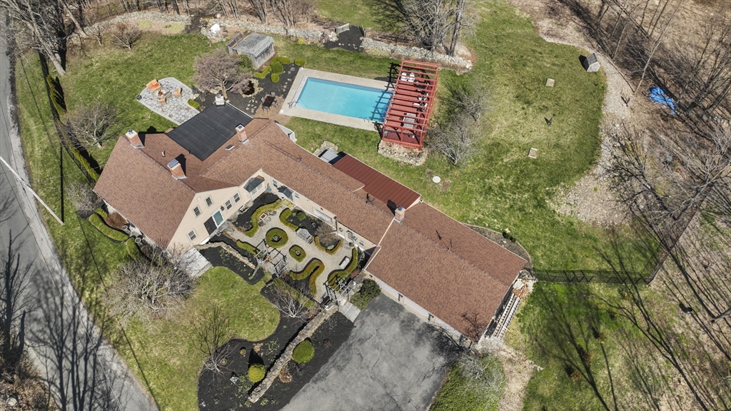 an aerial view of a house with outdoor space