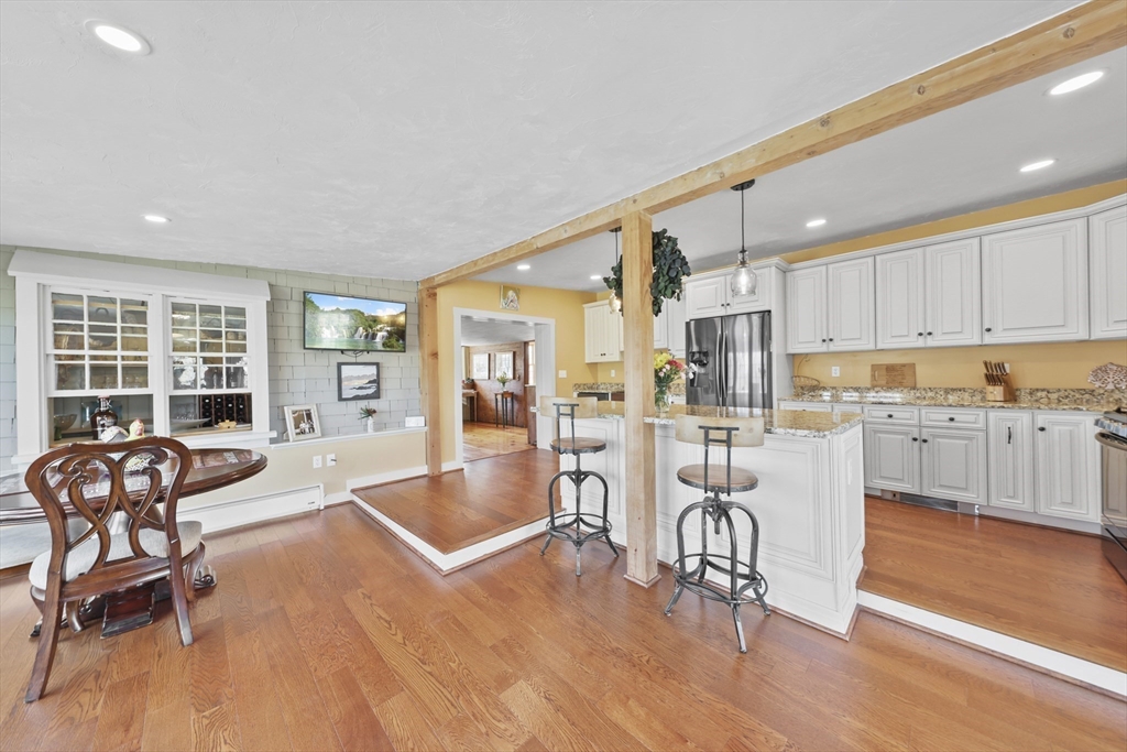 71 Prindle Hill Road Charlton, MA 01507 - Photo 12 of 40 a view of a kitchen with kitchen island dining table and wooden floor