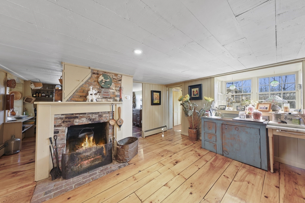 71 Prindle Hill Road Charlton, MA 01507 - Photo 22 of 40 a living room with stainless steel appliances furniture a fireplace and a flat screen tv