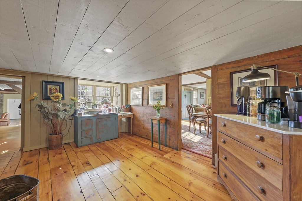 71 Prindle Hill Road Charlton, MA 01507 - Photo 23 of 40 a large room with lots of wooden furniture a large window and stainless steel appliances