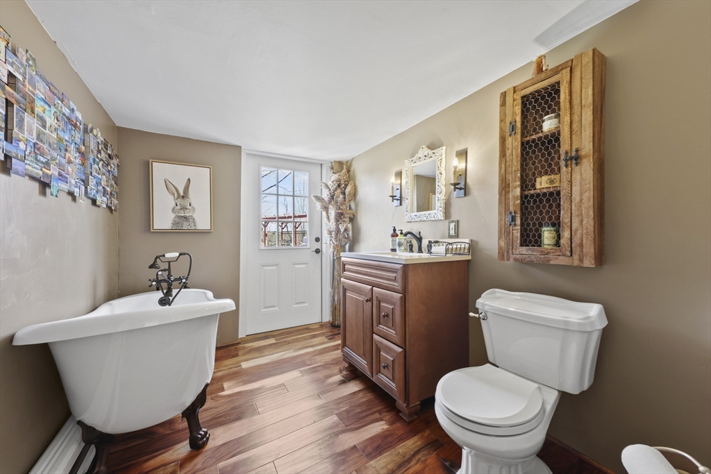 71 Prindle Hill Road Charlton, MA 01507 - Photo 24 of 40 a bathroom with a granite countertop toilet a sink and a mirror