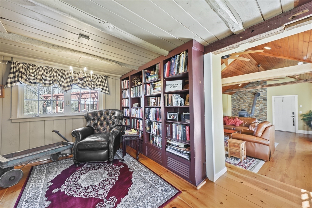 71 Prindle Hill Road Charlton, MA 01507 - Photo 28 of 40 a living room with furniture or couch and a book shelf