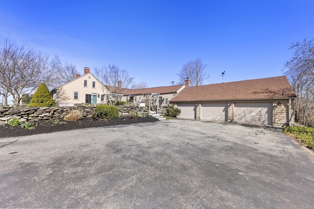 71 Prindle Hill Road Charlton, MA 01507 - Photo 37 of 40 a front view of a house with a yard and garage