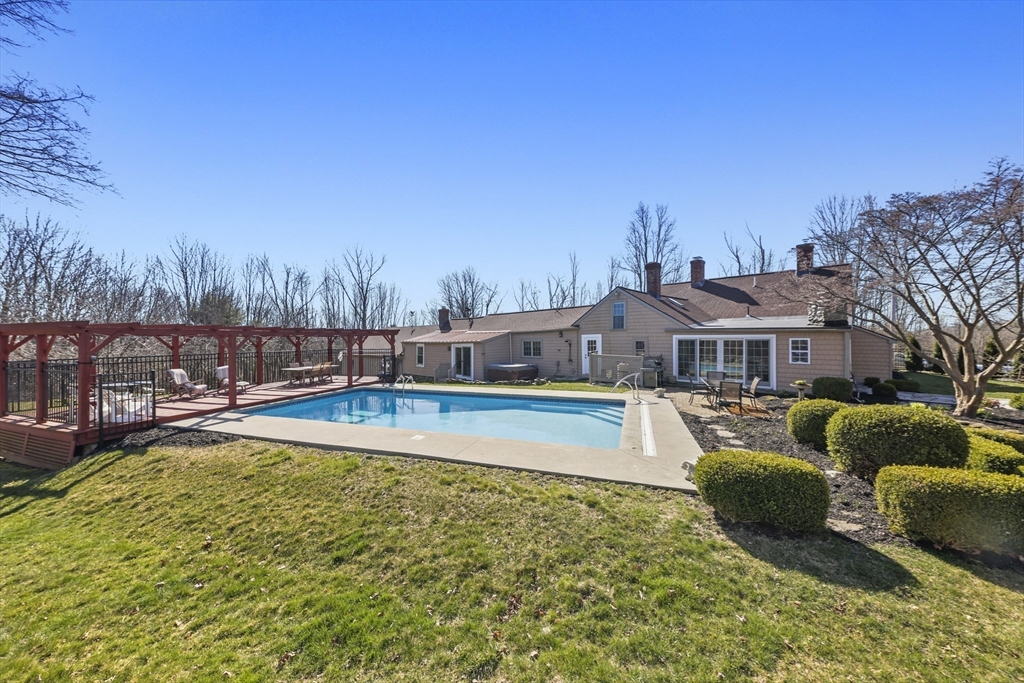 71 Prindle Hill Road Charlton, MA 01507 - Photo 38 of 40 a view of a swimming pool with couches chairs and a table and chairs