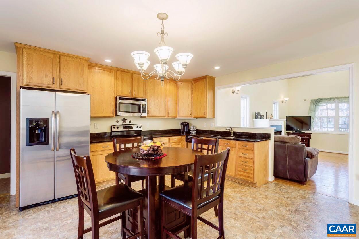 29 Stonewall Road Palmyra, VA 22963 - Photo 6 of 22 a view of a dining room with furniture a kitchen and chandelier