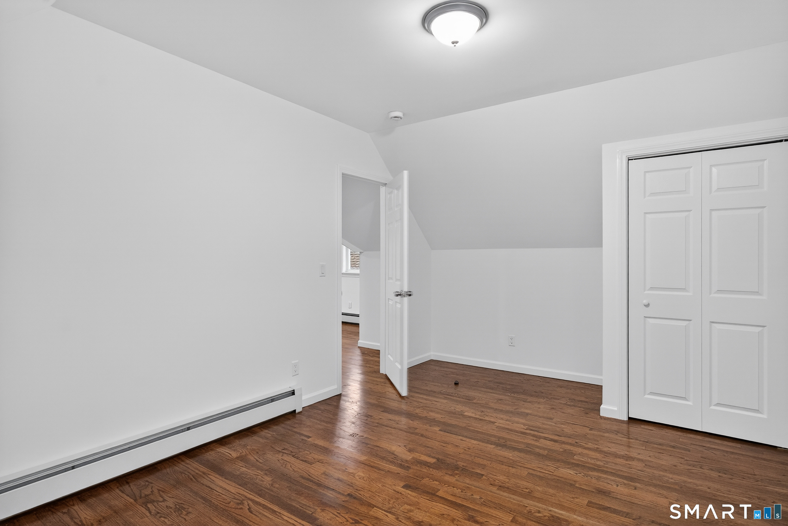 144 Cottage Street, Unit 3 Bridgeport, CT 06605 - Photo 11 of 12 an empty room with wooden floor